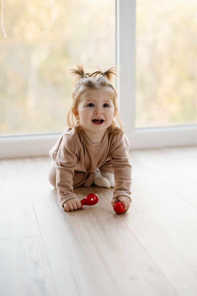 Baby girl crawling on floor