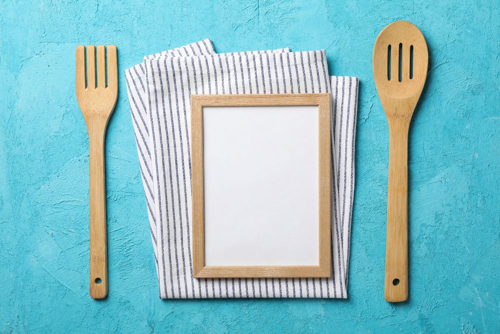 Kitchen cutlery, napkin and blank space for text on blue background
