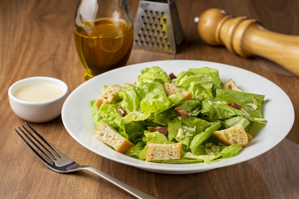Caesar salad with croutons and bacon.