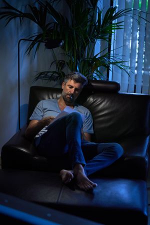 Serious businessman working late in dark office room