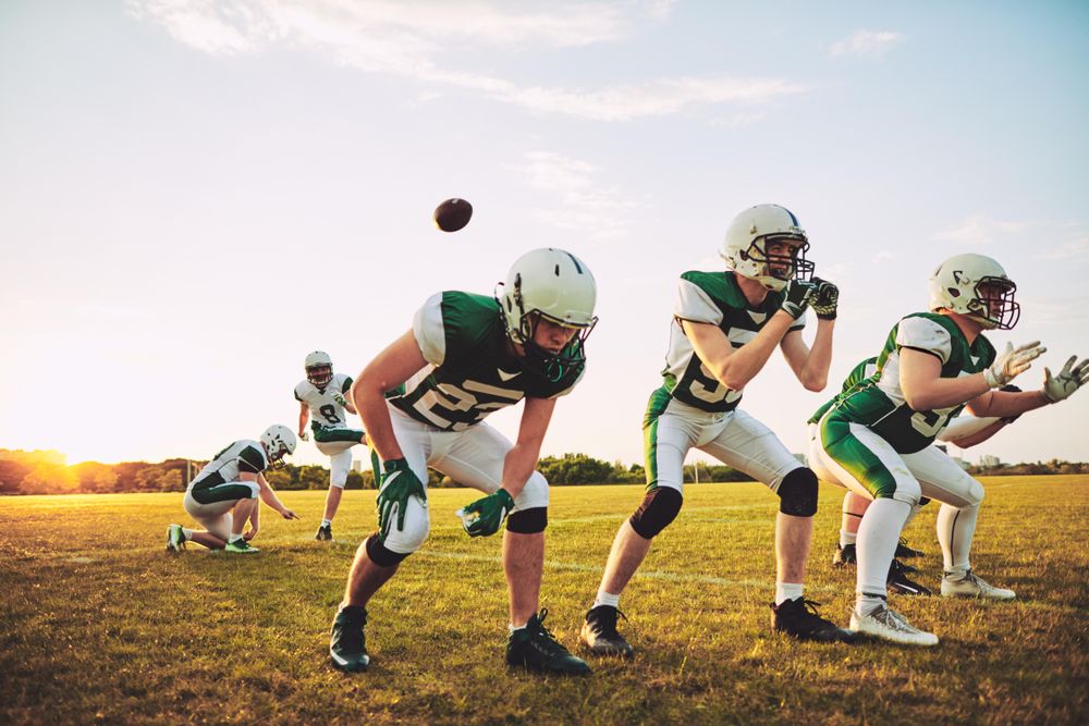 Football team passing the ball to each other during practice