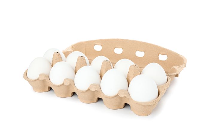 chicken eggs in carton box isolated on blank background