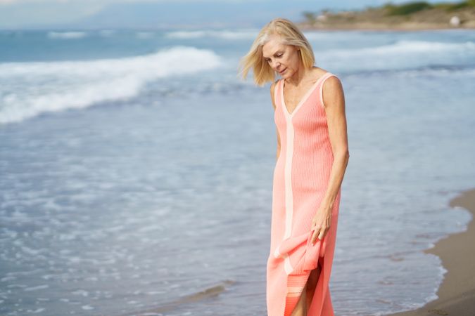 Calm woman walking along the coast