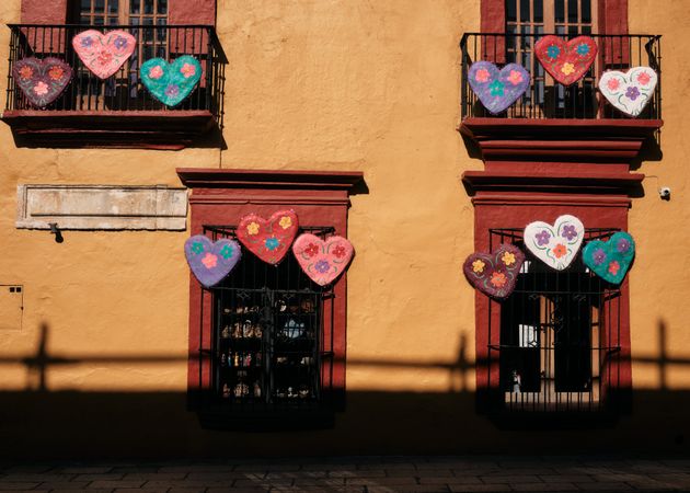 Painted heart decorating window balconies in Oaxaca with fence