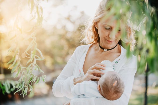 woman feeding a baby with a bottle