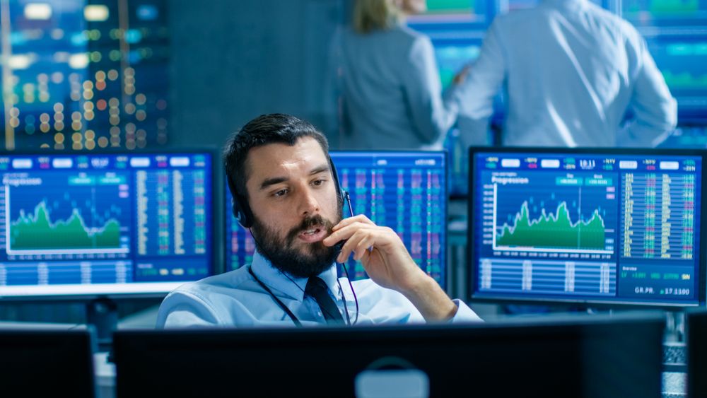 Stock Exchange Trader Makes a Deal with Big Client Over the Headset.