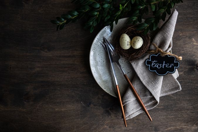 Grey spring table setting with nest, eggs and rabbit napkin ring