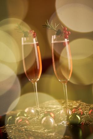 Champagne glasses near Christmas baubles