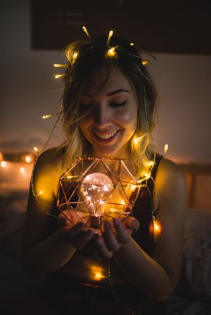 Woman surrounded with light garland