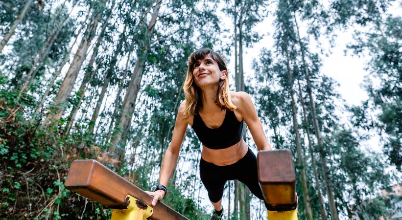 Athlete woman training on parallel bars