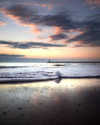 Calm sea waves crashing on shore during sunrise