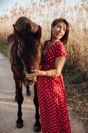 Young woman with horse on ranch