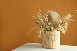 Beautiful dried floral arrangement in wicker basket  with copy space