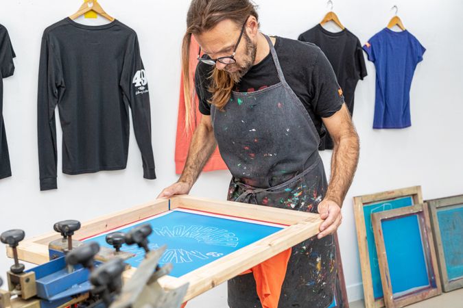 Artist printing screen in workshop
