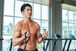 Athletic male stretching and bodybuilding for healthy body