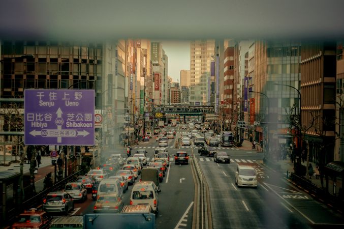 Cars on road near high rise buildings in Japan