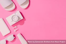 Summer objects of sunglasses, camera, smart phone and sunscreen, EarPods on pink background 49kBW0