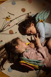 Little girls in angel costume sleeping over soft mat