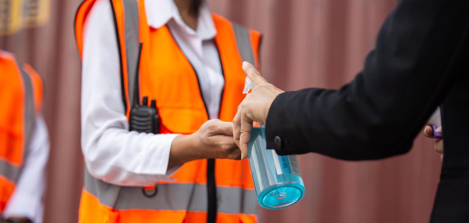 Staff receiving hand sanitizer on construction site