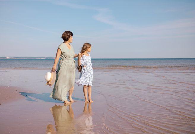 Beach stroll with mother and daughter
