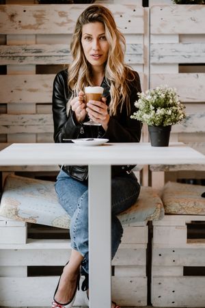 Woman drinking coffee from a glass