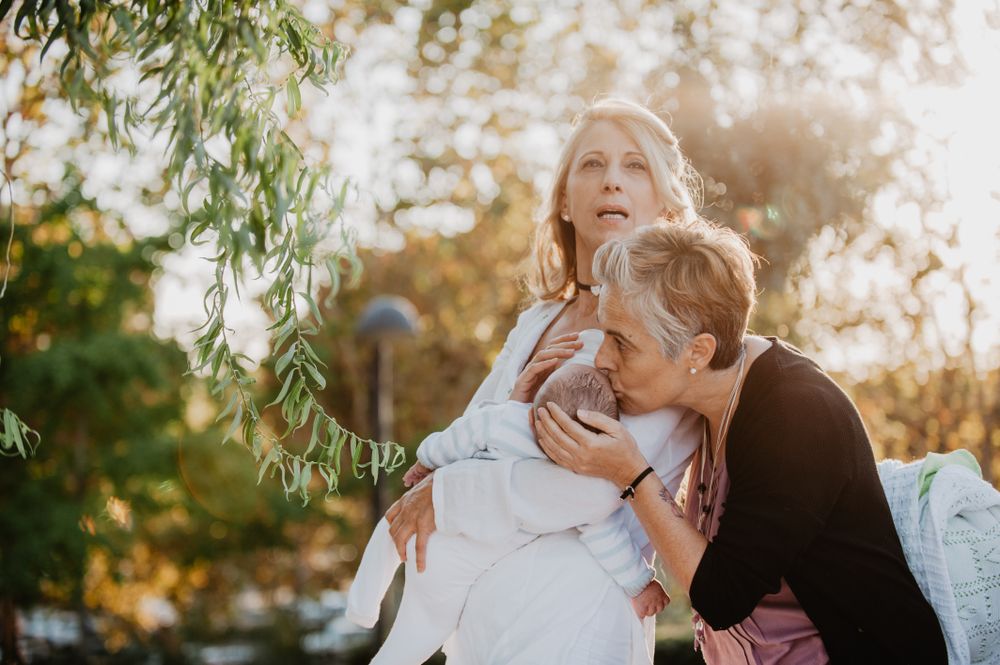 Two mature women with a baby in the park