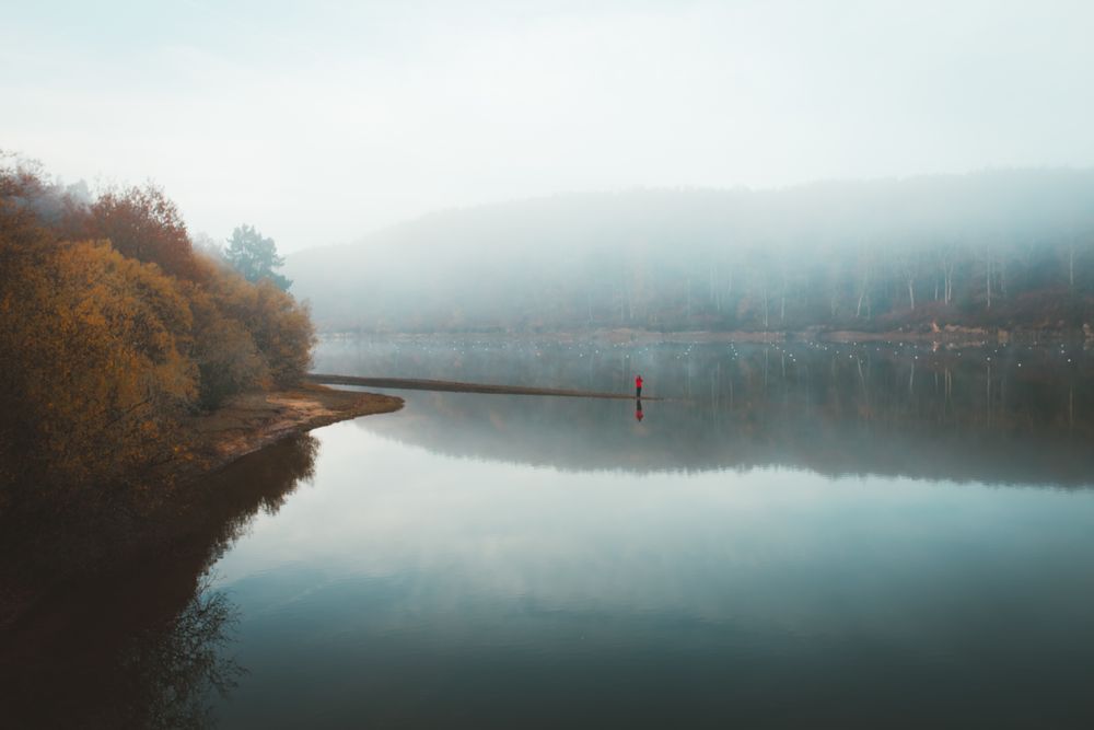 Beautiful tranquil lake in fog