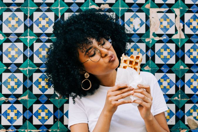 Cheerful Black female with tasty waffle