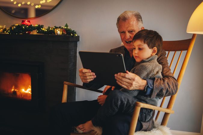 Grandfather and grandson using a digital tablet