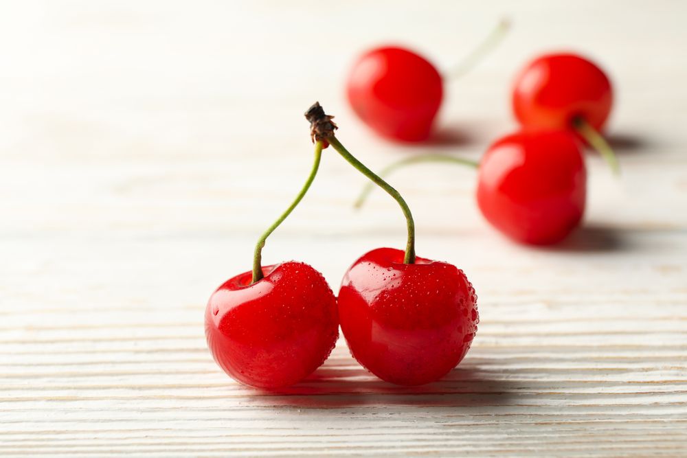 Fresh red cherry on wooden background, close up
