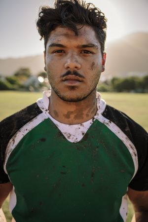 Close up portrait of young rugby player smeared in mud