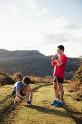Sportive males taking break after running in mountains