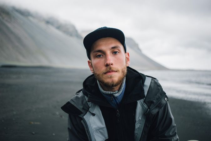 Portrait of man on dark sand beach
