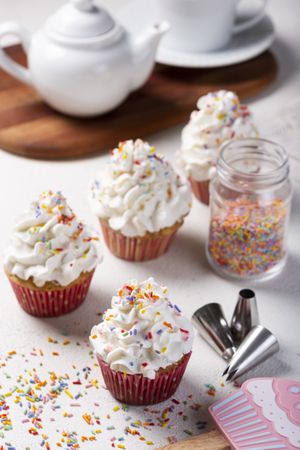 Tasty party cupcakes on the table. Cupcakes with whipped cream.