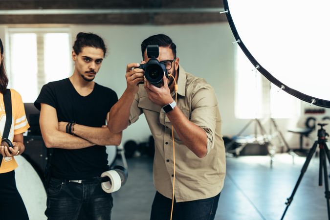 Photographer with his team doing a photo shoot in a studio