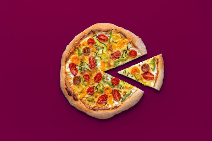 Vegetarian pizza minimalist on a magenta background, top view