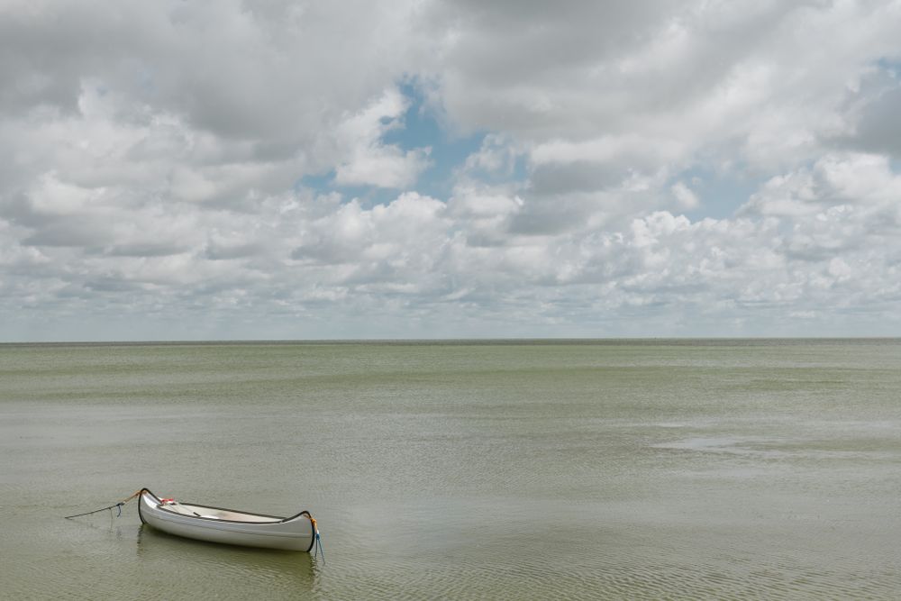 Seascape with fishing boat in silent water