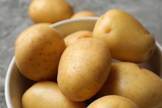 Close up of fresh potatoes in ceramic bowl