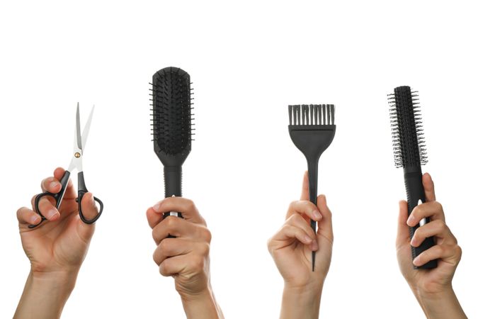 Female and male hands hold hairdressing tools, isolated on blank background