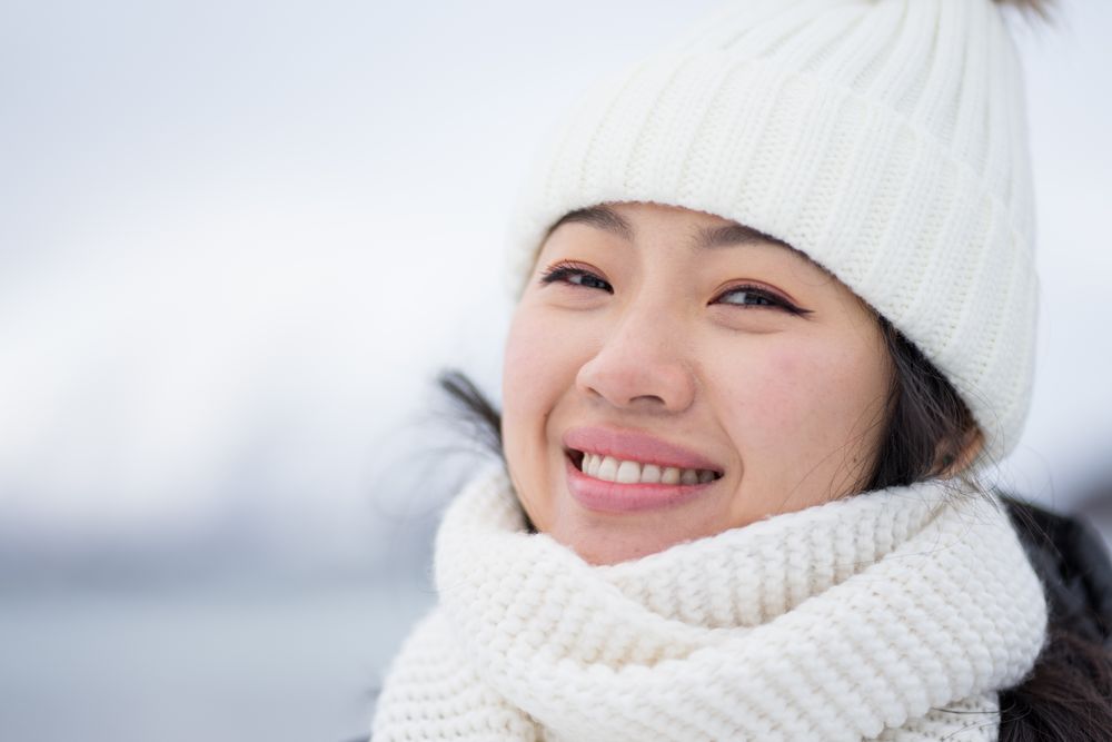 Joyful young woman in warm clothes
