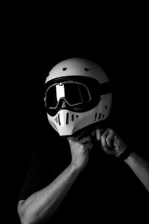 Rider in helmet and glasses at studio