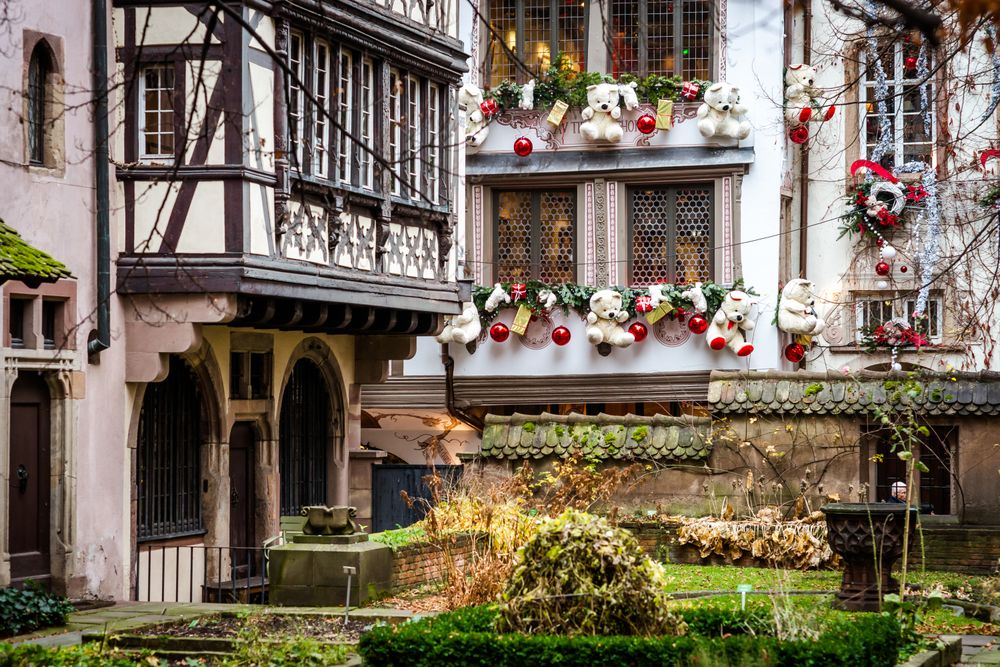 Square in Strasbourg, France with windows lined with Christmas decorations