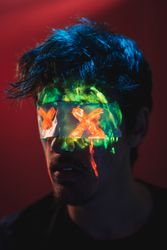 Male with covered eyes and neon face