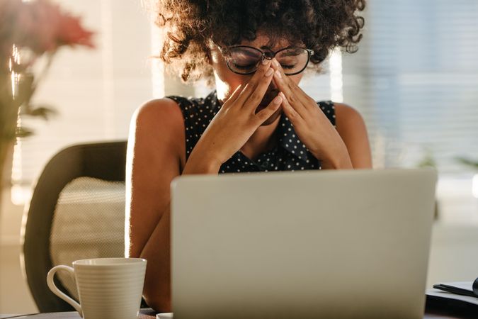 Stressed woman working at her desk