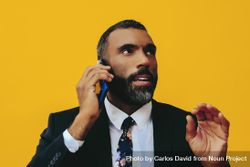 Calm Black businessman having a call on a smartphone screen 5l8QN5