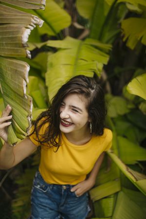 Dreamy female near tropical bush