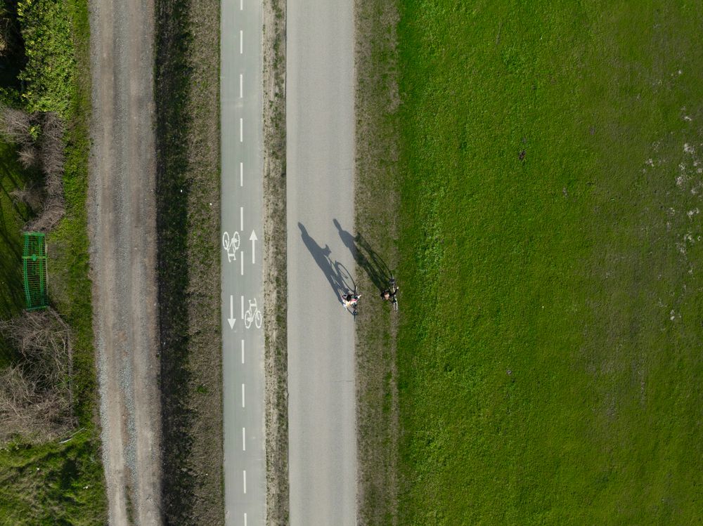 Aerial photo of two persons enjoying a summer day on their bikes.