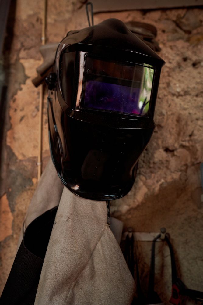 Mask of welder hanging on wall