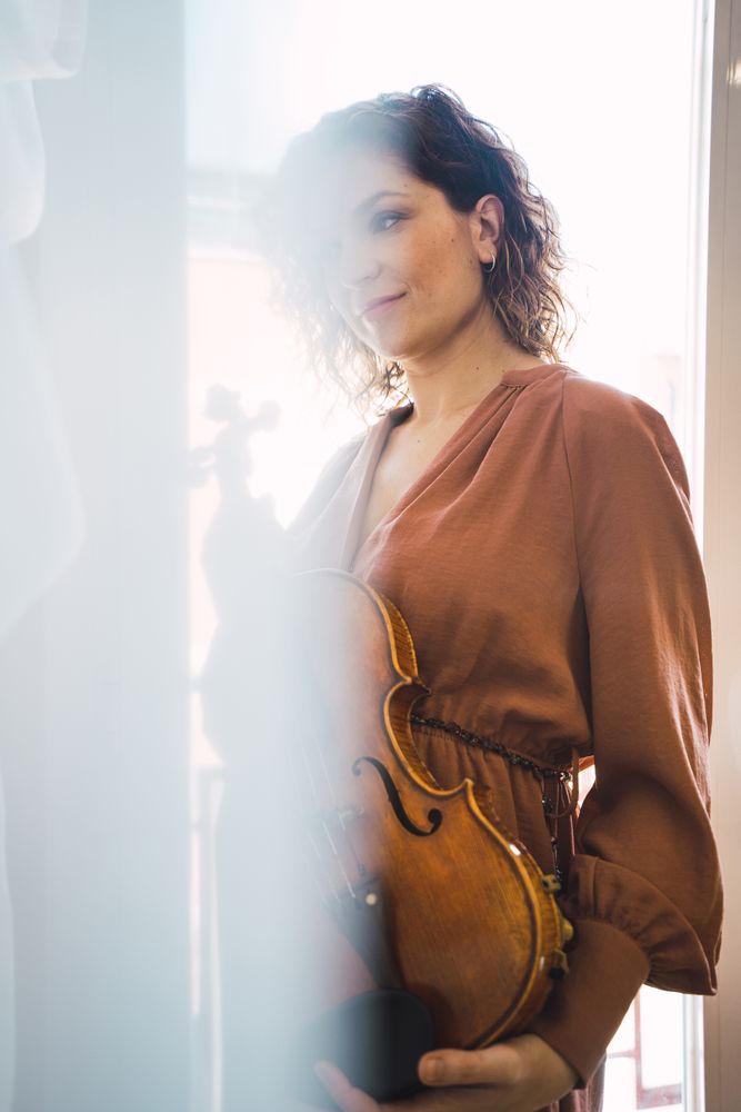Young smiling woman with violin