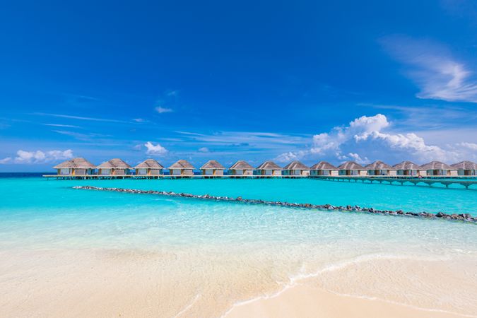 Crystal clear tropical water with overwater bungalows